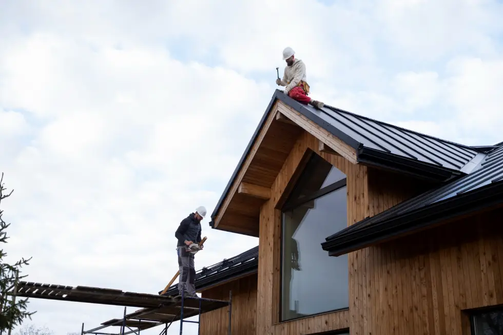 Long shot men working on roof